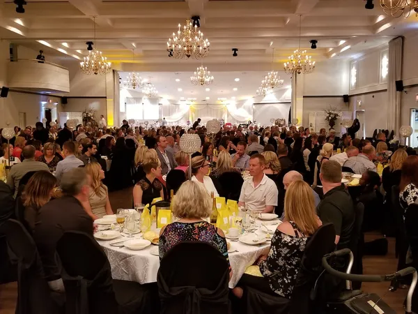 A full banquet hall of seated guests during the gala dinner