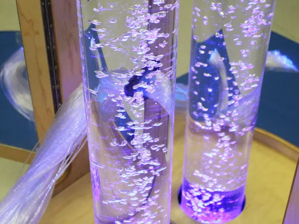 Two bubble tubes lit in violet, reflected in the cart’s mirrored panel